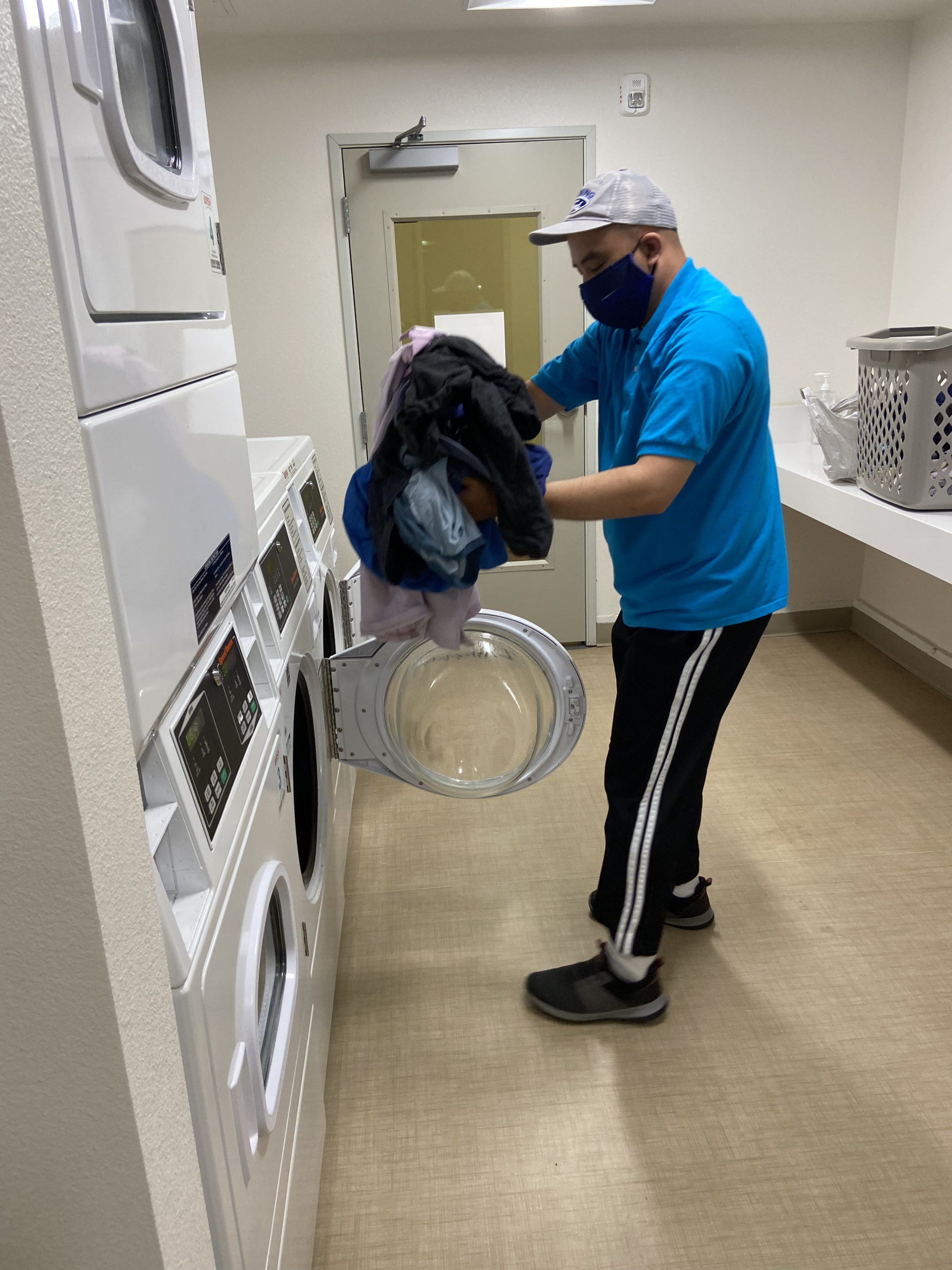 David putting his laundry in the dryer at Irby Ranch.