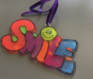 Colorful necklace with the word "Smile" that Jennifer made Pratima.