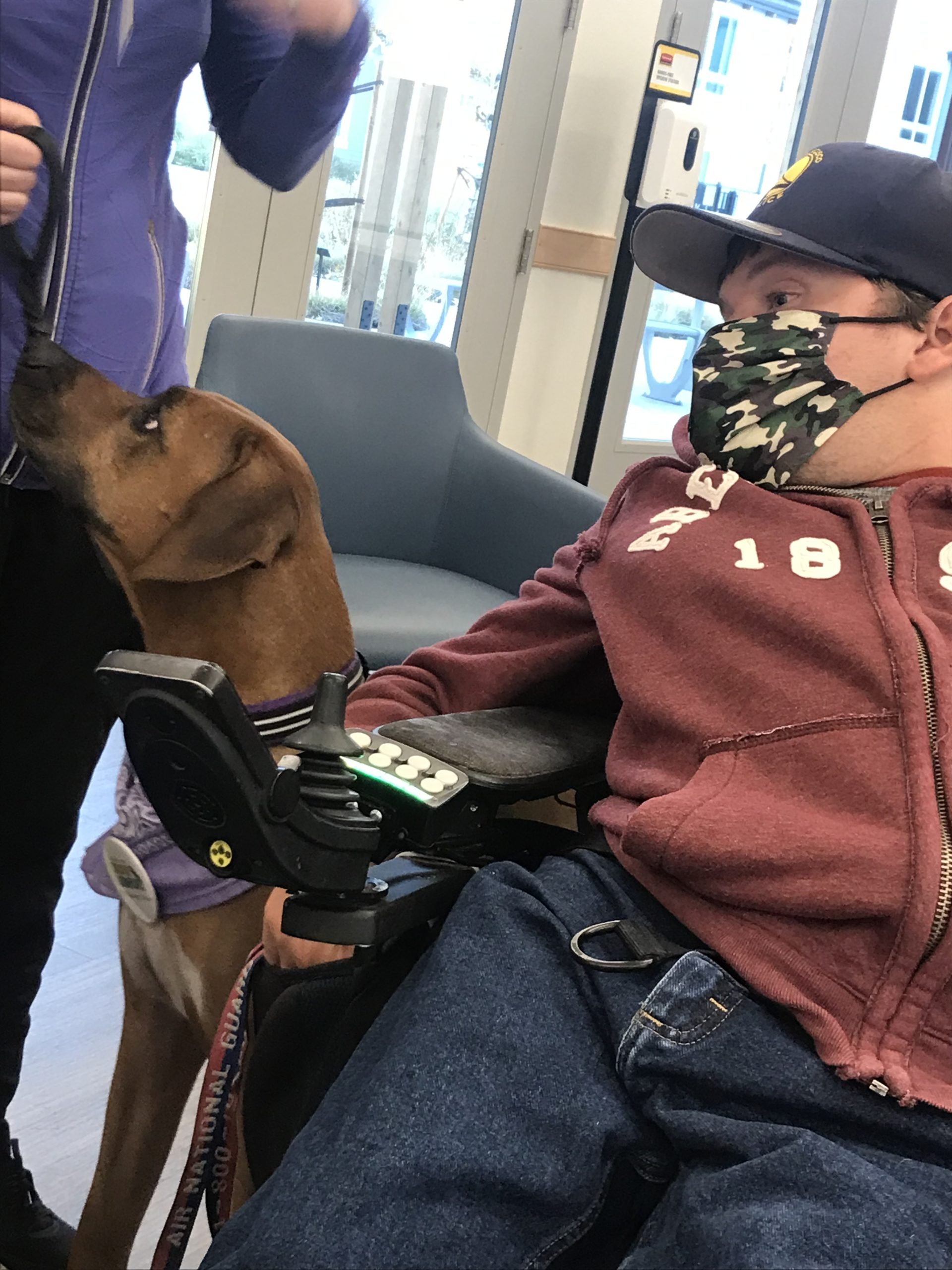 Kyle petting a dog during pet therapy
