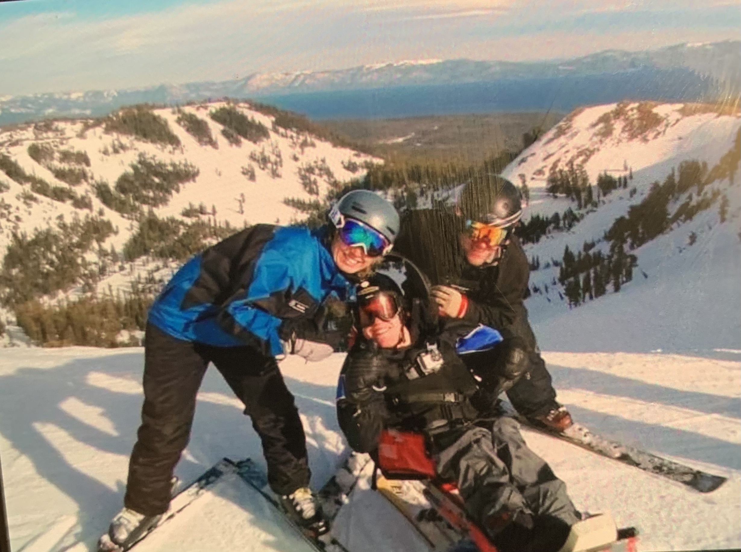 Kyle on skis in the snow with his family.
