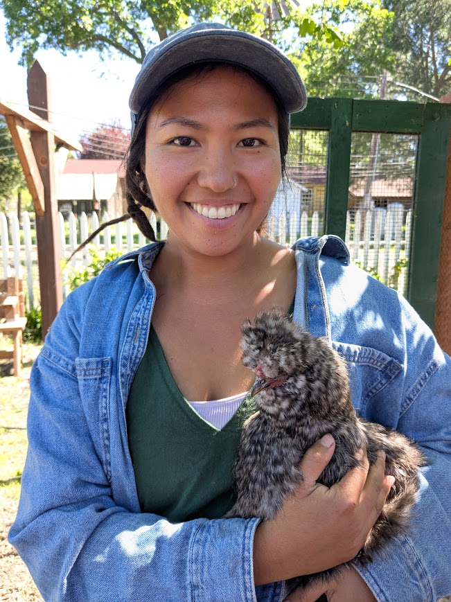 Sunflower Hill Garden Manager holding chicken