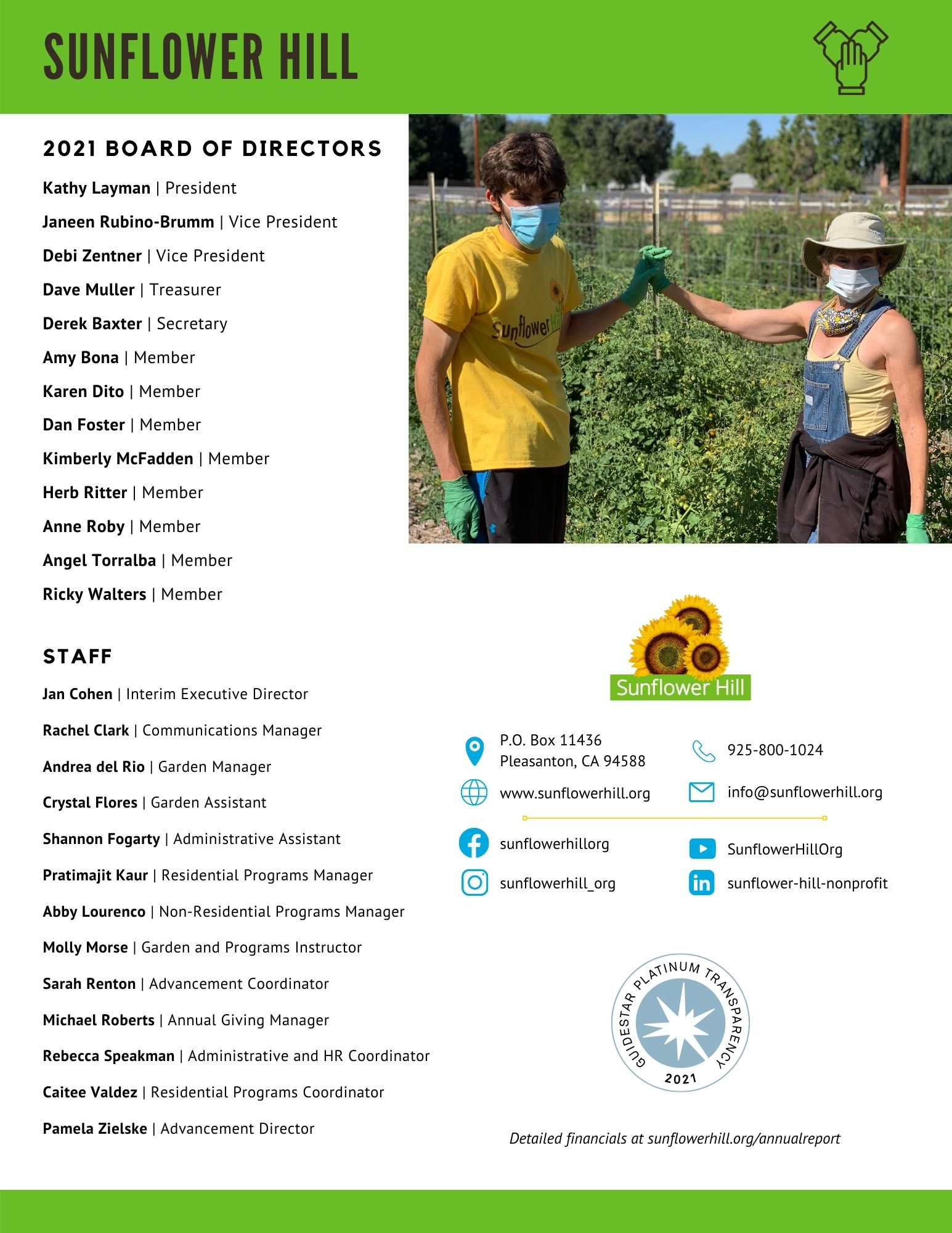 Garden volunteers holding hands with tomatoes in the background.